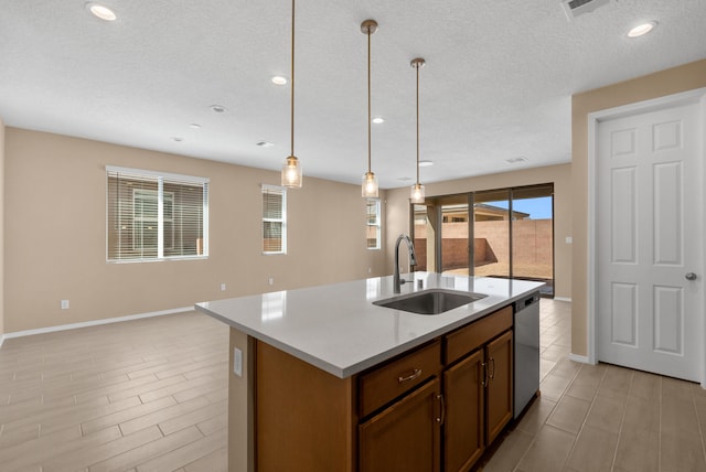 kitchen with a sink, stainless steel dishwasher, open floor plan, light countertops, and hanging light fixtures