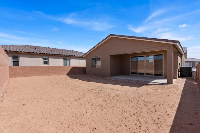 back of house featuring a patio area, cooling unit, a fenced backyard, and stucco siding