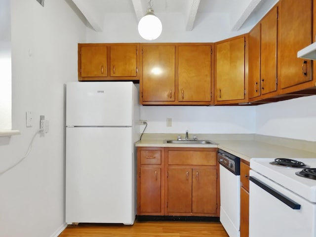 kitchen with beam ceiling, sink, white appliances, and light hardwood / wood-style flooring