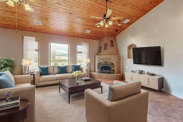 tiled living room featuring a large fireplace, lofted ceiling, ceiling fan, and wood ceiling