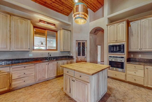 kitchen featuring sink, high vaulted ceiling, wood ceiling, stainless steel oven, and wood counters