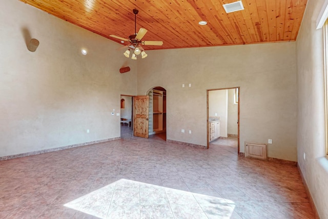 empty room featuring high vaulted ceiling, light tile patterned flooring, wooden ceiling, and ceiling fan