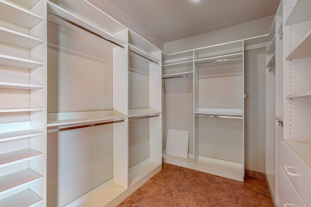 walk in closet with light tile patterned flooring