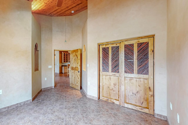 interior space with a high ceiling and wood ceiling