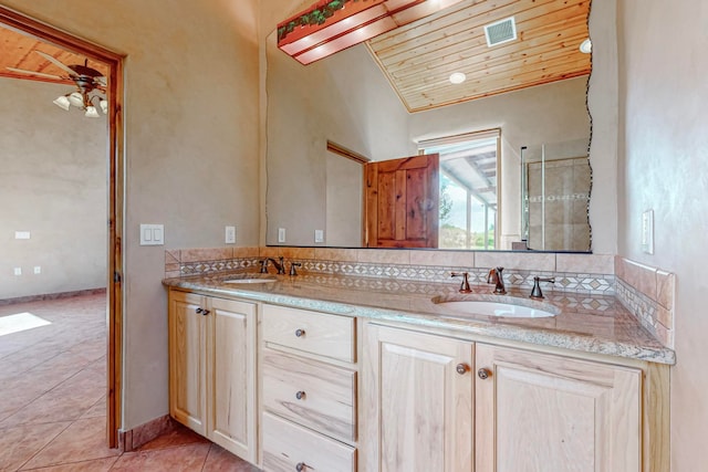 bathroom with vanity, wood ceiling, vaulted ceiling, and tile patterned floors