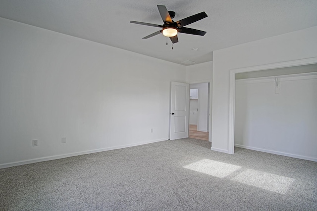 unfurnished bedroom with carpet, a textured ceiling, ceiling fan, and a closet