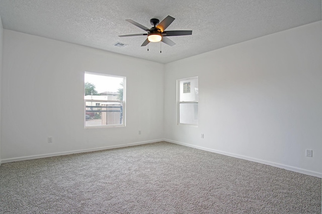 empty room featuring carpet flooring, a textured ceiling, and ceiling fan