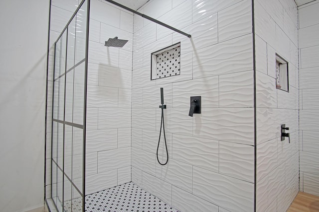 bathroom with a tile shower