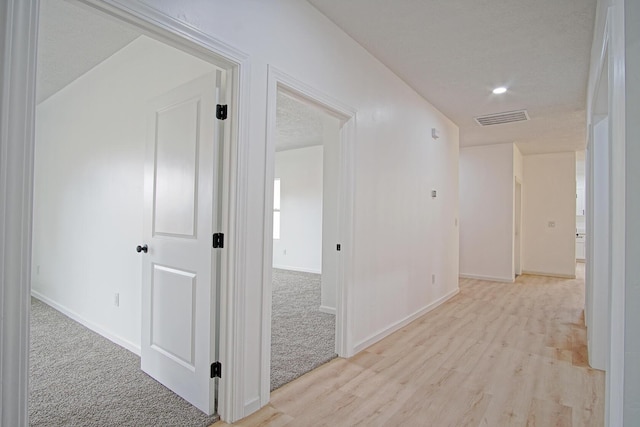 hallway with light wood-type flooring