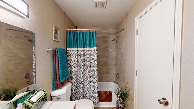 bathroom featuring shower / tub combo, a textured ceiling, and toilet