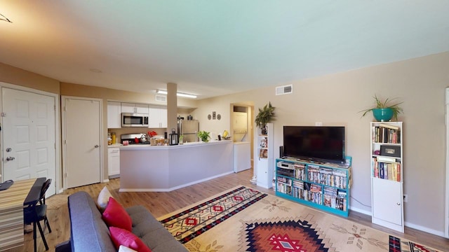 living room with light hardwood / wood-style floors