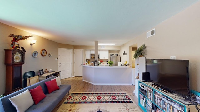 living room with light hardwood / wood-style flooring