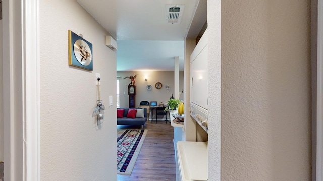 hallway with hardwood / wood-style flooring