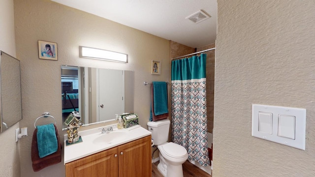 bathroom with a shower with curtain, vanity, and toilet