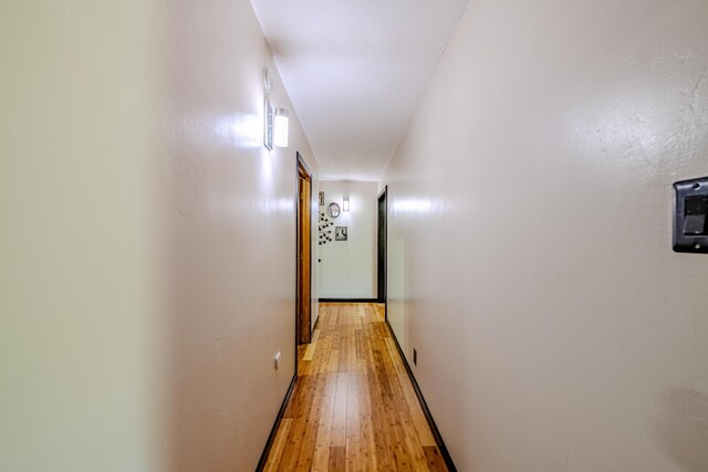 hallway with hardwood / wood-style floors