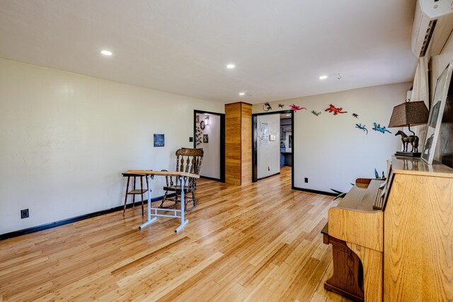 interior space featuring light hardwood / wood-style floors and a wall mounted air conditioner