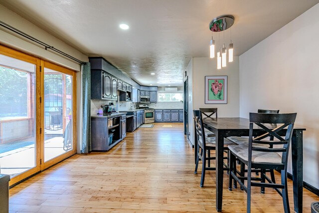 dining space featuring a notable chandelier and light hardwood / wood-style floors