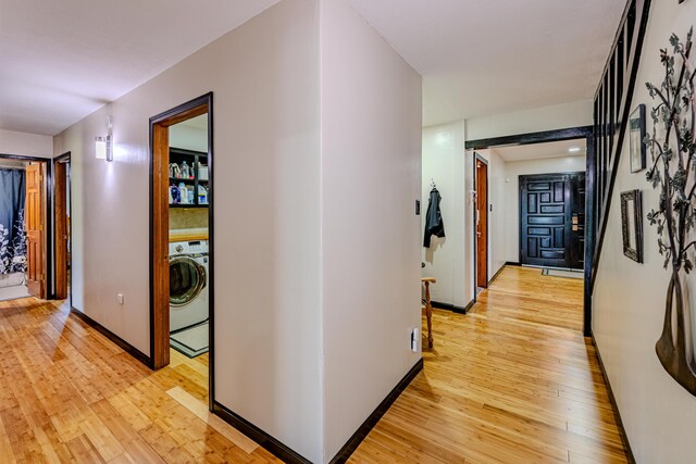 hallway featuring light hardwood / wood-style floors and washer / clothes dryer