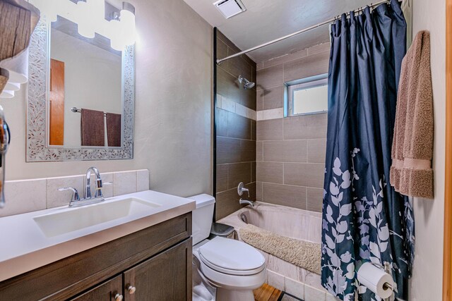 full bathroom with shower / bath combo, tasteful backsplash, toilet, and vanity