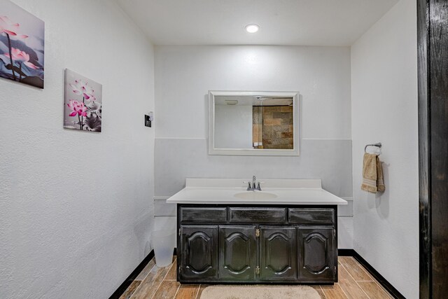 bathroom with hardwood / wood-style floors and vanity