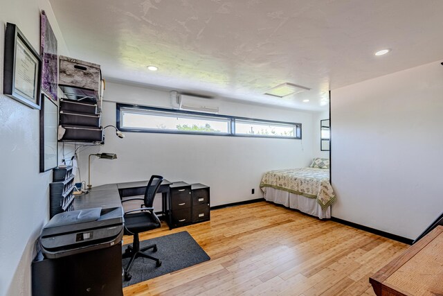 office with wood-type flooring and a wall unit AC