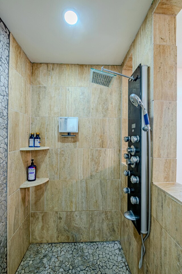 bathroom with a tile shower