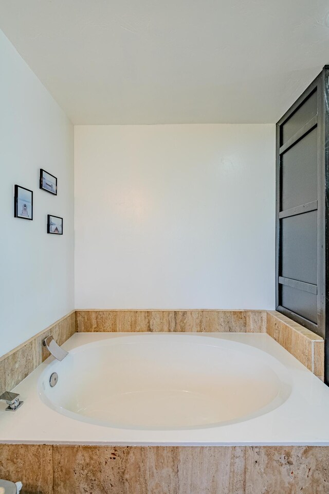 bathroom with tiled tub