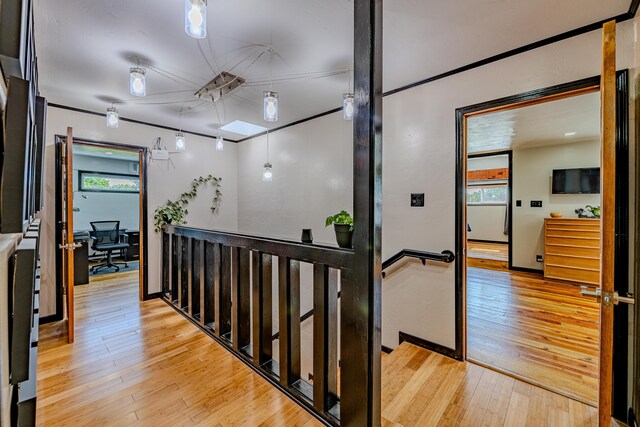 corridor with light hardwood / wood-style flooring