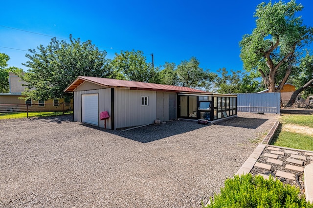 garage featuring an outdoor structure