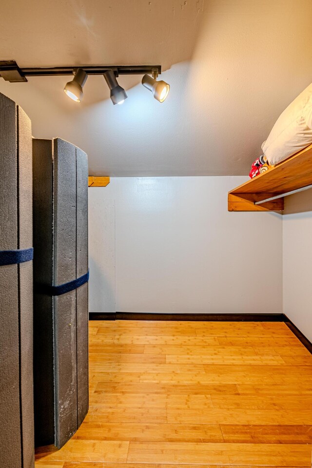 interior space with light wood-type flooring and rail lighting