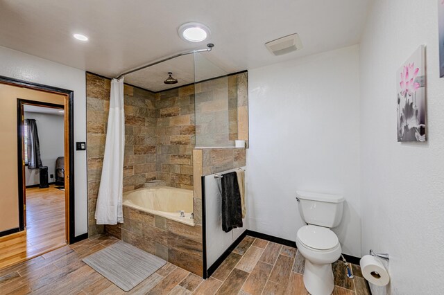 bathroom with toilet and hardwood / wood-style floors