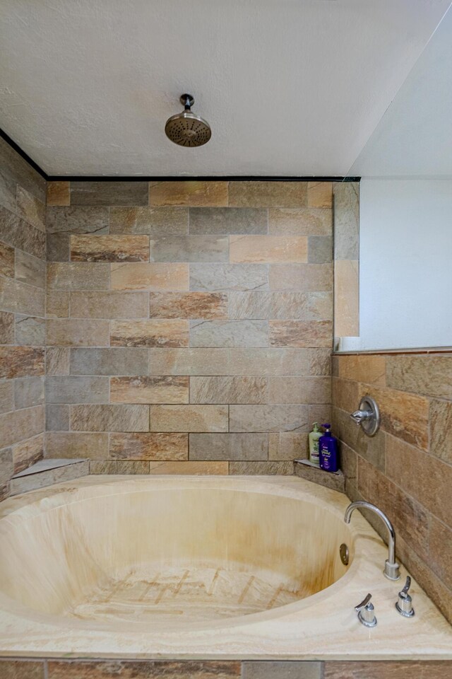 bathroom featuring tiled bath