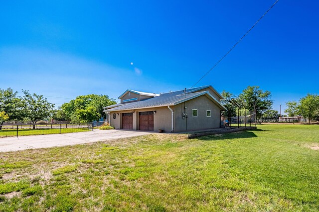 view of front of house featuring a trampoline, a garage, and a front yard