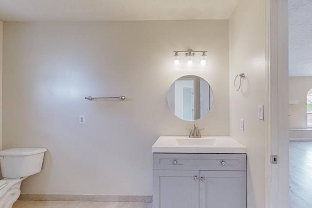 bathroom featuring tile patterned flooring, vanity, and toilet