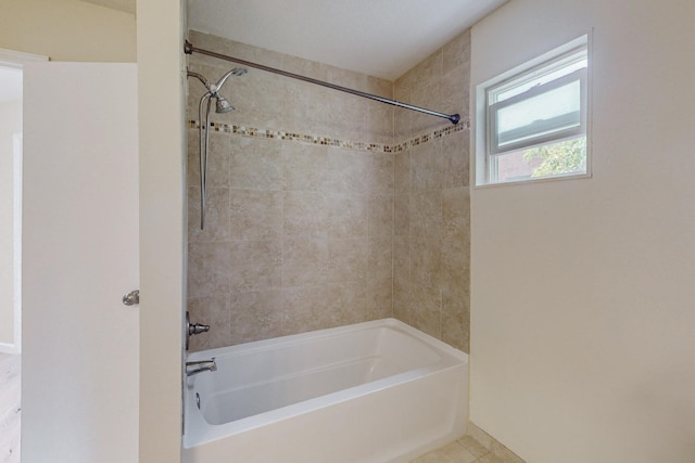 bathroom with tile patterned flooring and tiled shower / bath