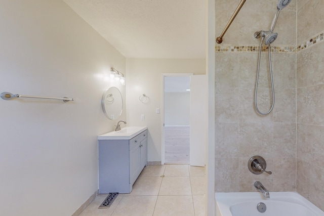 bathroom with tile patterned floors, tiled shower / bath combo, and vanity