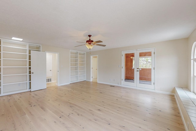 unfurnished living room with ceiling fan, light hardwood / wood-style flooring, and french doors