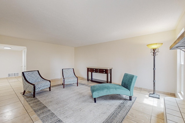 living area featuring a healthy amount of sunlight and light tile patterned floors