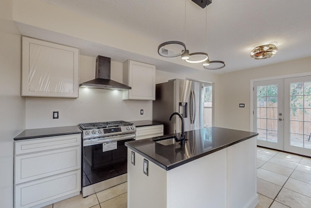 kitchen with french doors, sink, wall chimney exhaust hood, decorative light fixtures, and stainless steel appliances