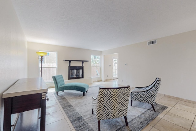 living room with light tile patterned floors and a textured ceiling