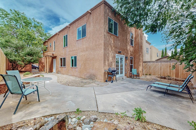 back of property with french doors and a patio area