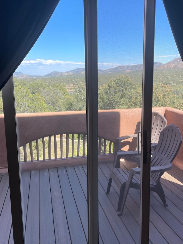 wooden deck featuring a mountain view