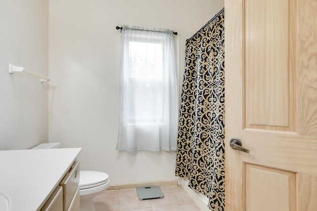 bathroom featuring tile patterned flooring, vanity, and toilet