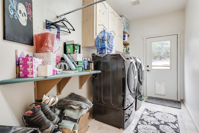 washroom with washing machine and dryer and light tile patterned floors