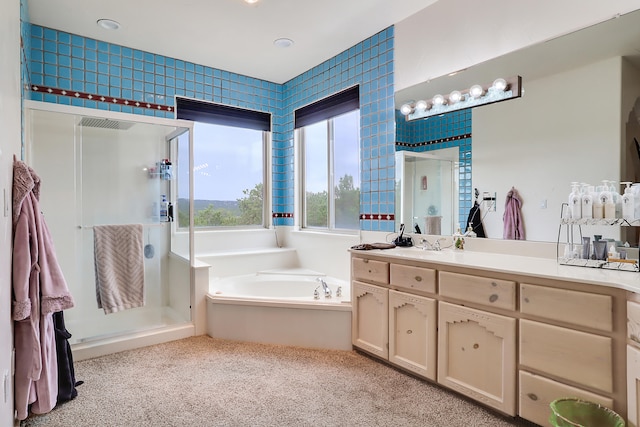 bathroom with shower with separate bathtub and vanity