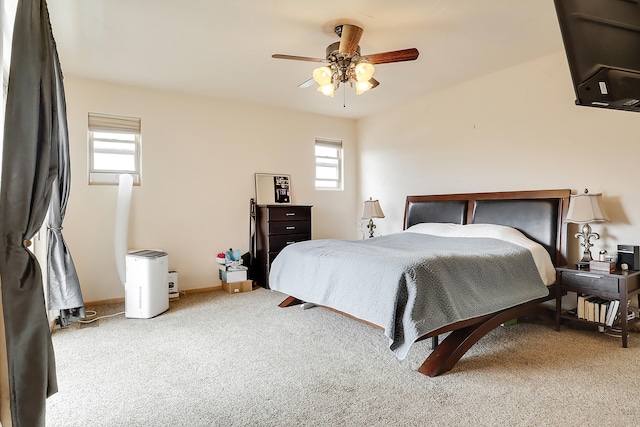 bedroom with light carpet and ceiling fan