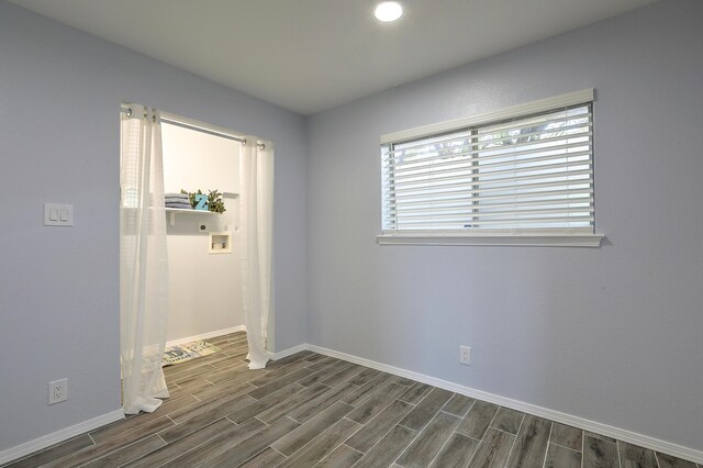 empty room with dark wood-type flooring