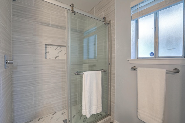 bathroom featuring plenty of natural light and an enclosed shower