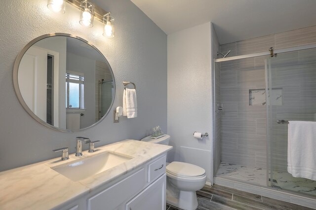 bathroom with vanity, toilet, and walk in shower