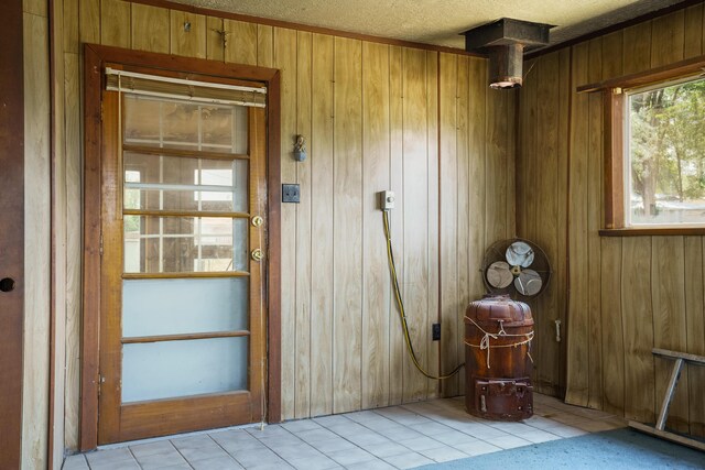 interior space featuring light tile patterned flooring and wooden walls